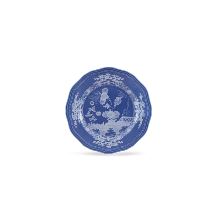 A blue and white porcelain plate with a delicate hand-painted floral and landscape design, centered on a clean white background.