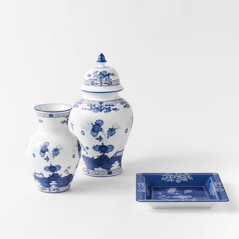 Make a striking interior statement with the Ginori 1735 Oriente Italiano Indaco Ming vase, handcrafted in Sesto Fiorentino, Italy. Sculpted from pure Italian porcelain, this iconic vessel features delicate indigo-blue floral carnations unfurling across a luminous white surface, uniting classical Florentine ceramic heritage with the timeless poise of historic Asian silhouettes.