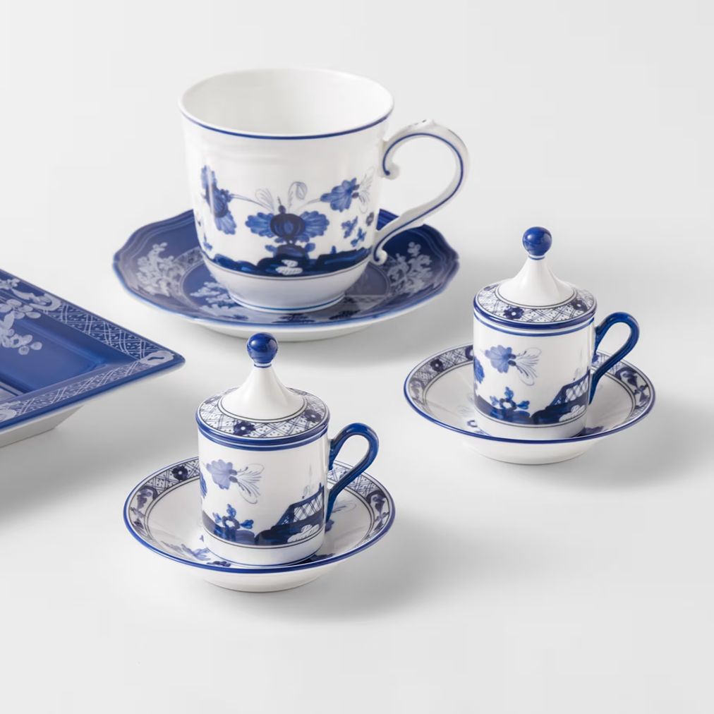 Blue and white porcelain tea or coffee cup set with matching saucers, lids, and a rectangular serving tray on a clean white background.