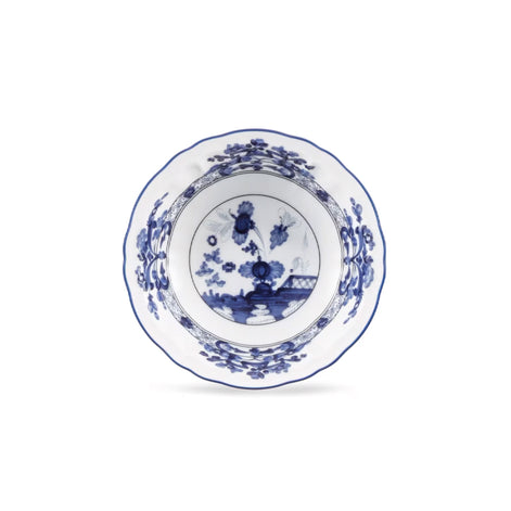 A white ceramic bowl with a blue floral and landscape pattern, photographed from directly above on a clean white background.