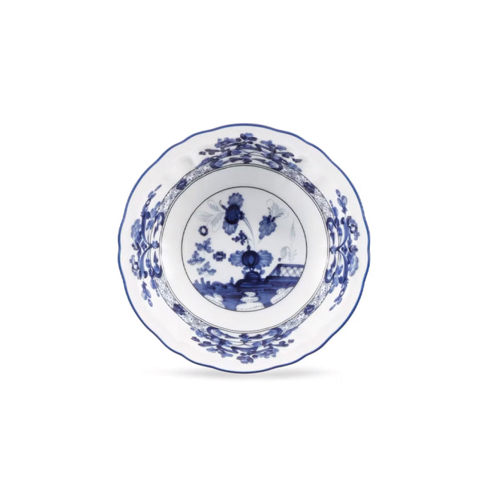 A white ceramic bowl with a blue floral and landscape pattern, photographed from directly above on a clean white background.