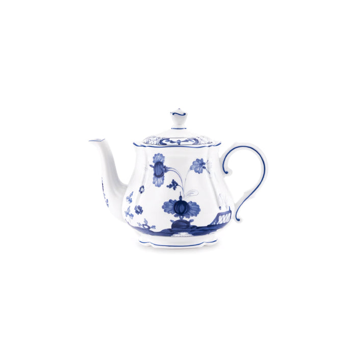 A classic white porcelain teapot decorated with intricate blue floral and landscape patterns, set against a solid white background.