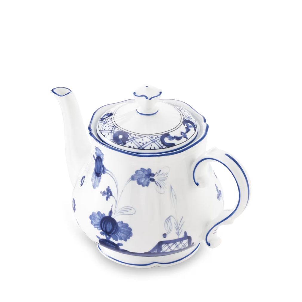 A white porcelain teapot decorated with blue floral and scroll patterns, shown on a clean white background.