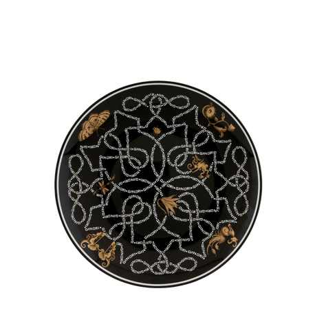 A round black ceramic plate featuring an intricate white dotted geometric knotwork pattern and gold-toned decorative motifs, shown from a top-down view on a white background.