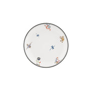 A white ceramic plate with a thin black rim, decorated with small, colorful hand-painted motifs including a blue dragonfly, a brown monkey, and a red snake, shown on a plain white background.
