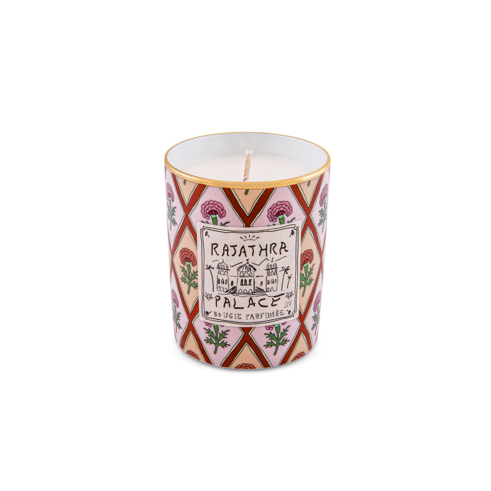 Transport your senses to the royal palaces of Rajasthan with the Rajathra Palace Scented Candle from the Profumi Luchino Collection by Ginori 1735. Inspired by one of the imaginary destinations cherished by British artist and designer Luke Edward Hall, this luxury home fragrance captures the elegance, mystery, and opulence of refined oriental interiors.