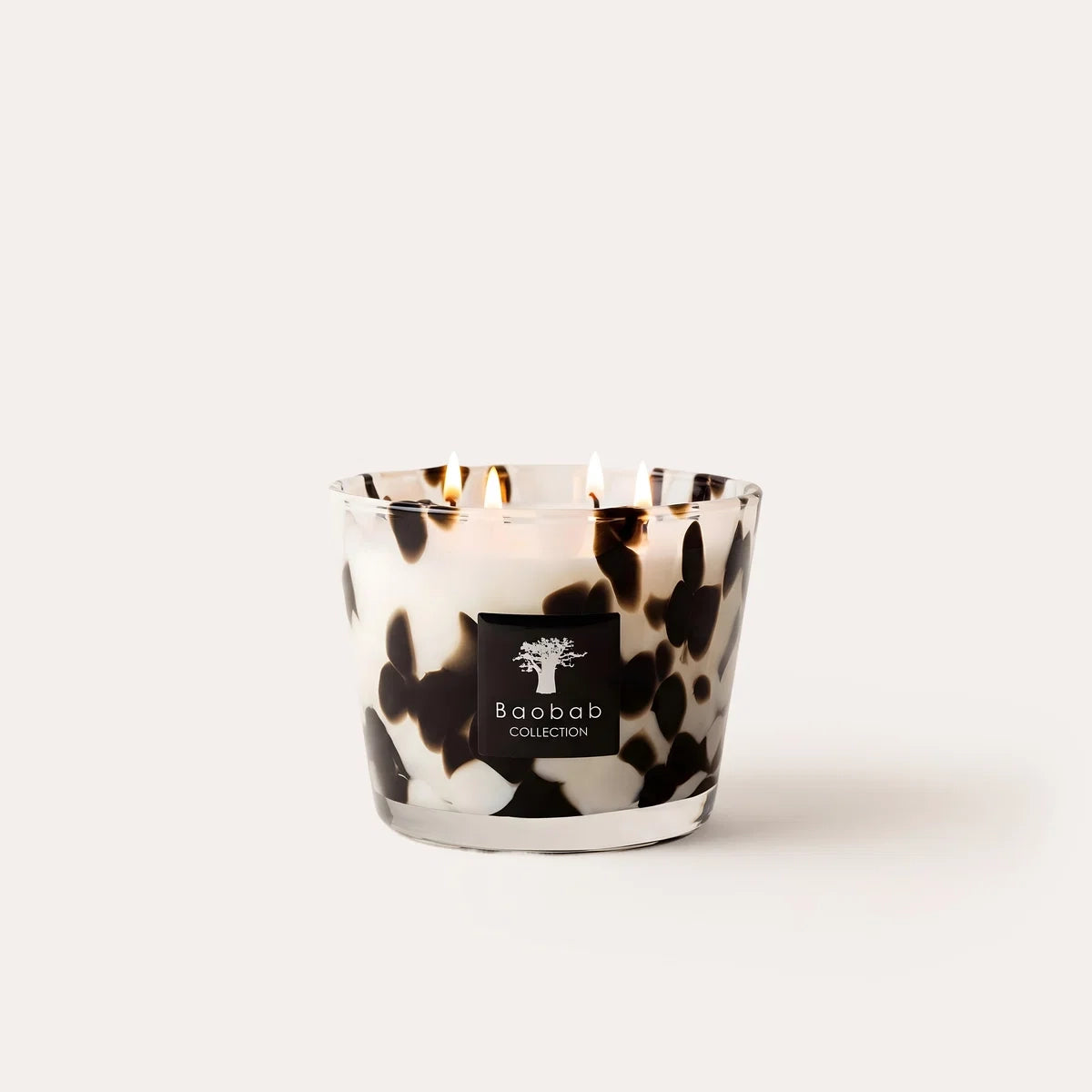 Limited edition Baobab Collection Black Pearls scented candle with hand-blown glass and the brand's iconic fragrance of ginger and black rose. Available in Max 10, Max 16, and Max 24 sizes for elegant home fragrance and sophisticated interiors. Archideco Interior Gallery | archideco-interior.com