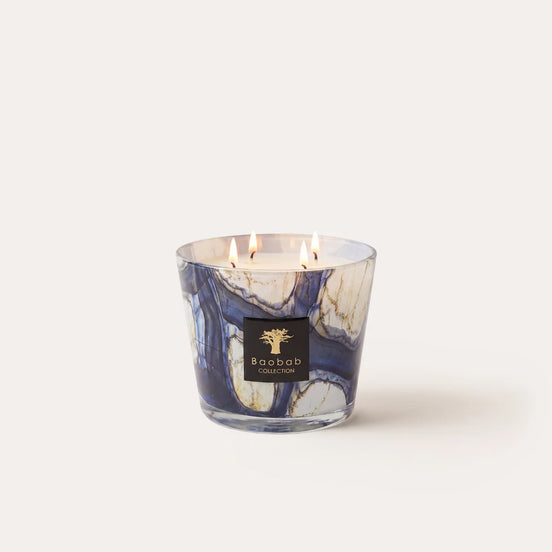 Baobab Collection Stones Lazuli scented candle with hand-blown blue marbled glass. Aromatic fragrance of cardamom, sea salt, and velvety musk. Available in Max 10 and Max 16 sizes for elegant home fragrance and luxury interiors. Archideco Interior Gallery | archideco-interior.com
