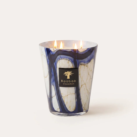 Baobab Collection Stones Lazuli scented candle with hand-blown blue marbled glass. Aromatic fragrance of cardamom, sea salt, and velvety musk. Available in Max 10 and Max 16 sizes for elegant home fragrance and luxury interiors. Archideco Interior Gallery | archideco-interior.com