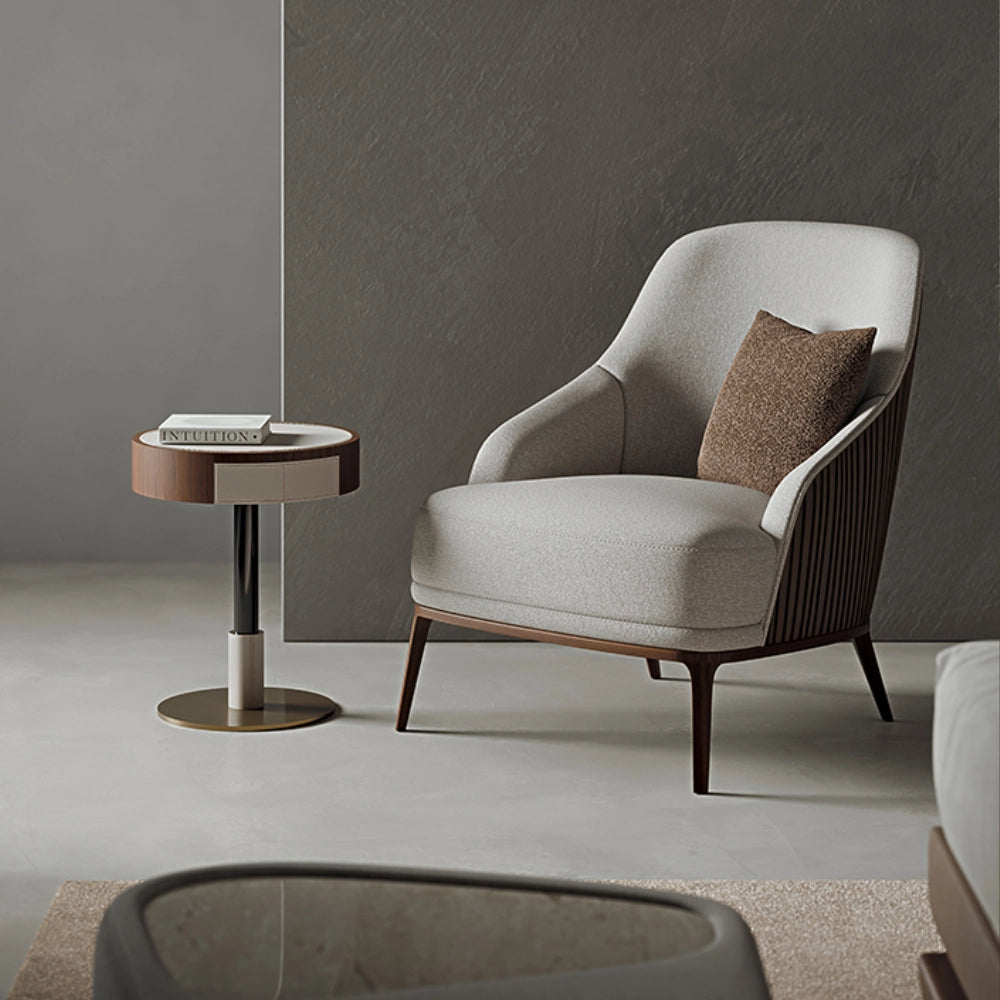 The Anita Armchair by Medea 1905, designed as part of the Tara Bernerd for Medea 1905 Collection, combines generous upholstered comfort with a refined wooden base and a softly architectural silhouette.