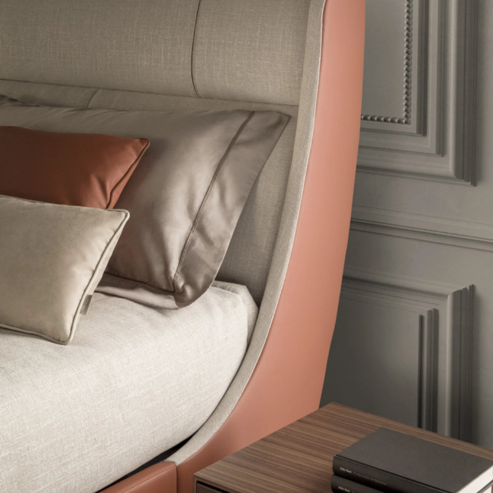 Defined by its gracefully curved upholstered headboard and footboard, Body wraps the sleeping area in a soft architectural embrace, creating an intimate retreat of comfort and elegance. The generous fabric upholstery is framed by solid Walnut Canaletto wood, whose warm grain and slender elevated base lend the composition lightness and refinement. Noble materials including wood and fine fabrics are brought together with balance and precision, reflecting Medea's commitment to harmonious design and meticulous 