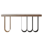 Defined by a sleek marble top resting on a rhythmic composition of slender looped metal legs, Iris transforms a functional silhouette into a sculptural statement. The airy U-shaped bases — rendered in contrasting dark and brushed gold finishes — create a sense of weightlessness and movement beneath the solid stone surface. Noble materials including marble and metal are brought together with balance and precision, reflecting Medea's commitment to harmonious design and meticulous artisan execution.