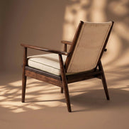 The Eloisa Chair by Medea 1905, designed as part of the Tara Bernerd for Medea 1905 Collection, brings together a sculptural wooden frame, a naturally woven straw backrest, and tactile leather upholstery to create a distinctive expression of contemporary Italian craftsmanship.