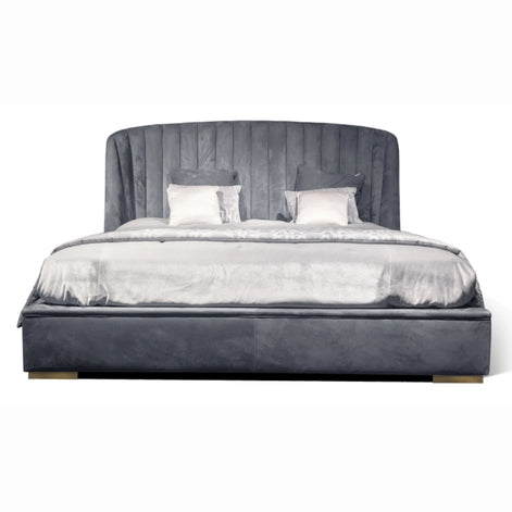 The Empire Bed by Medea 1905 embodies the essence of contemporary Italian living through refined craftsmanship, enveloping volumes, and luxurious materiality. Its signature wingback headboard, defined by elegant vertical channel stitching, rises in a graceful curve that gently wraps the sleeping area, creating a sense of intimacy