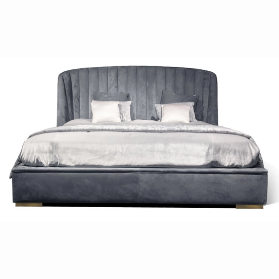 The Empire Bed by Medea 1905 embodies the essence of contemporary Italian living through refined craftsmanship, enveloping volumes, and luxurious materiality. Its signature wingback headboard, defined by elegant vertical channel stitching, rises in a graceful curve that gently wraps the sleeping area, creating a sense of intimacy