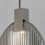 Close-up of a Terzani Harpe pendant showing its suspension cable, rectangular silver-tone light housing and vertical metal rods.
