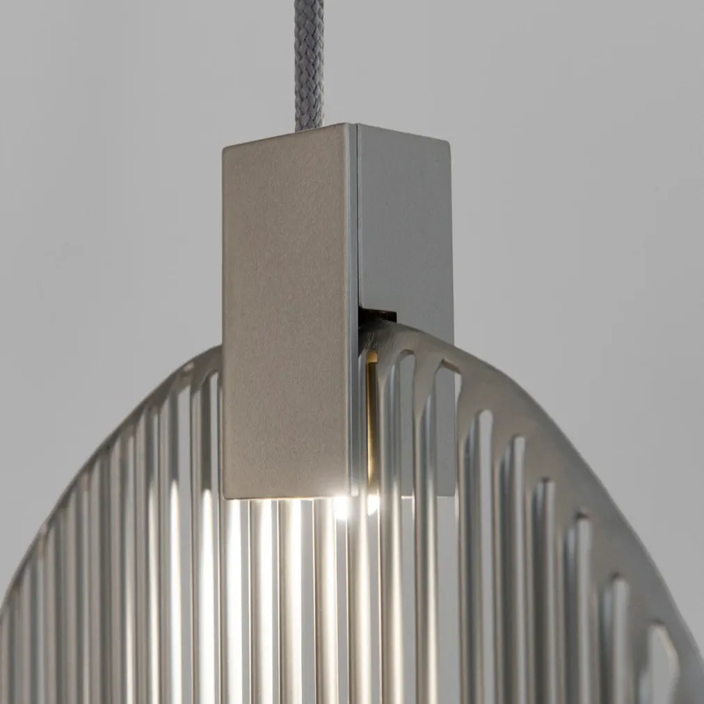 Close-up of a Terzani Harpe pendant showing its suspension cable, rectangular silver-tone light housing and vertical metal rods.