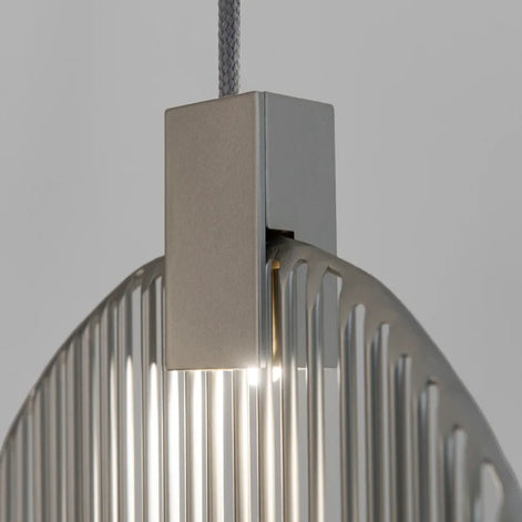 Close-up of a Terzani Harpe pendant showing its suspension cable, rectangular silver-tone light housing and vertical metal rods.