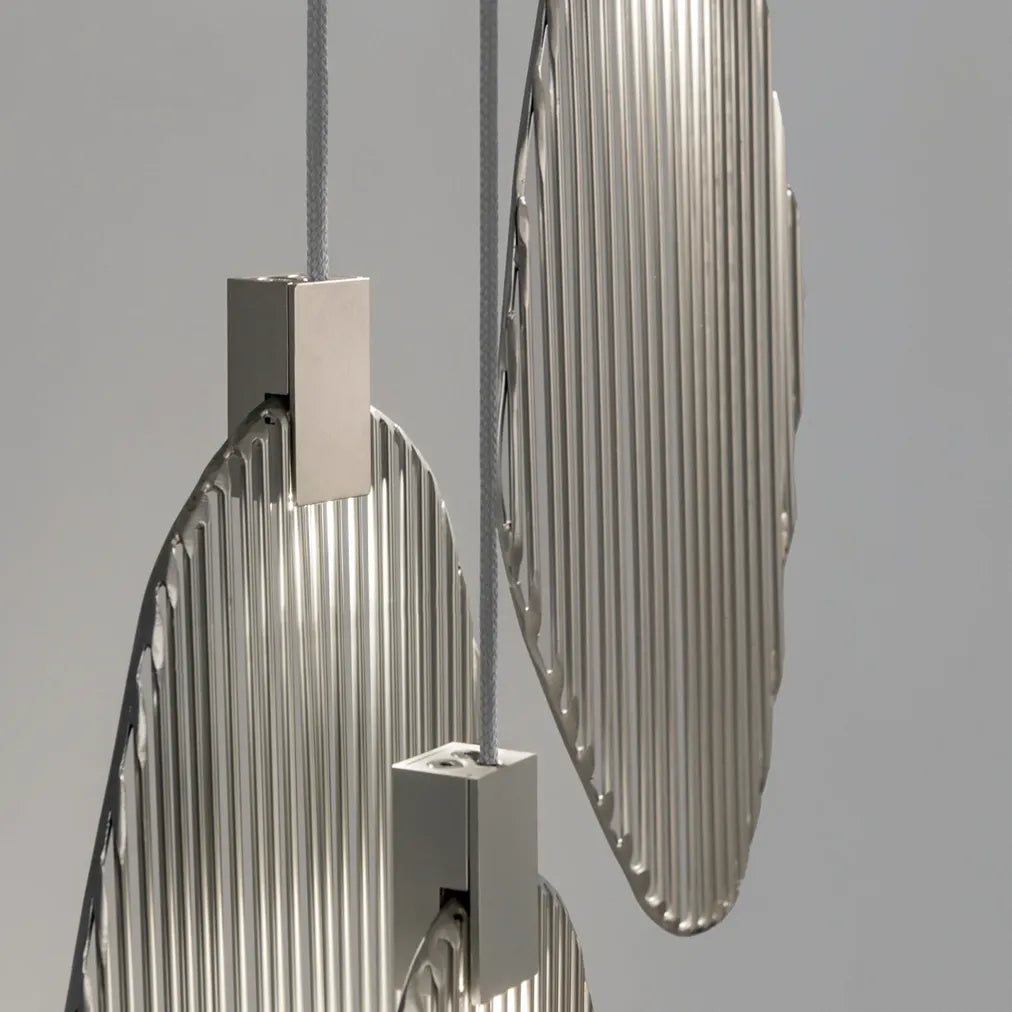 Close-up of overlapping Terzani Harpe pendant frames with polished vertical metal rods and rectangular silver-tone light housings.