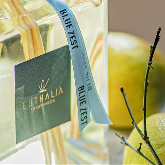 Euthalia fragrance bottle with 'Blue Zest' label and lemon in the background. At Archideco Interior Gallery.