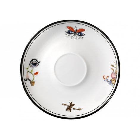 A white ceramic bowl with a black rim, decorated with whimsical hand-painted illustrations including a butterfly, an eye in a pot, a dragonfly, and floral motifs in orange, blue, pink, and brown.