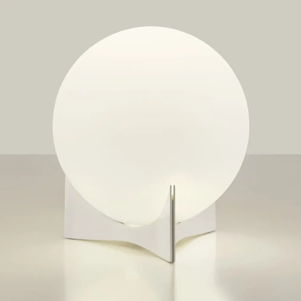 Front view of the Terzani Oscar table lamp with an illuminated opal glass globe and curved silver-tone base on a light background.